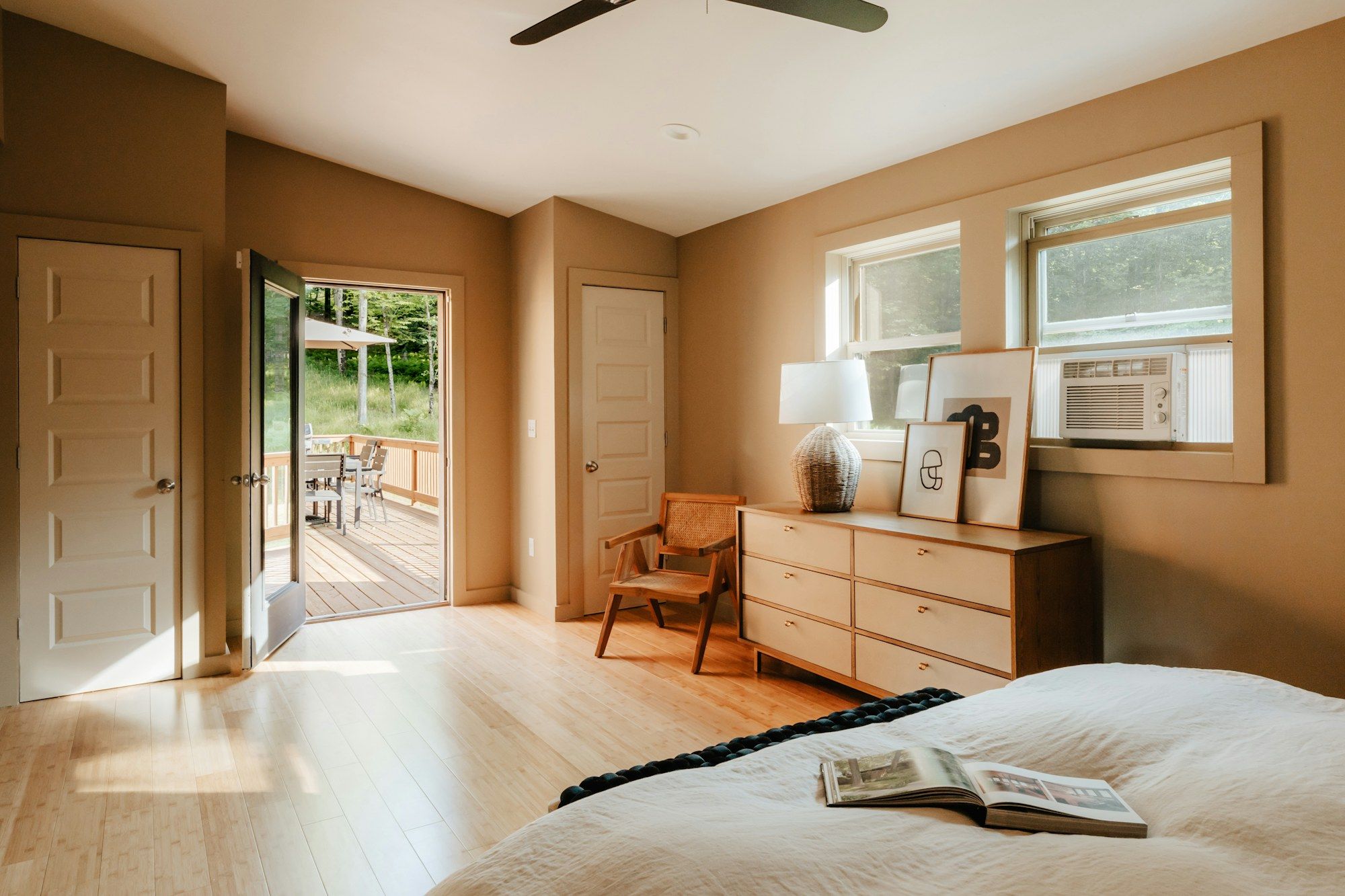 Bedroom with warm walls and a door open to the terrace