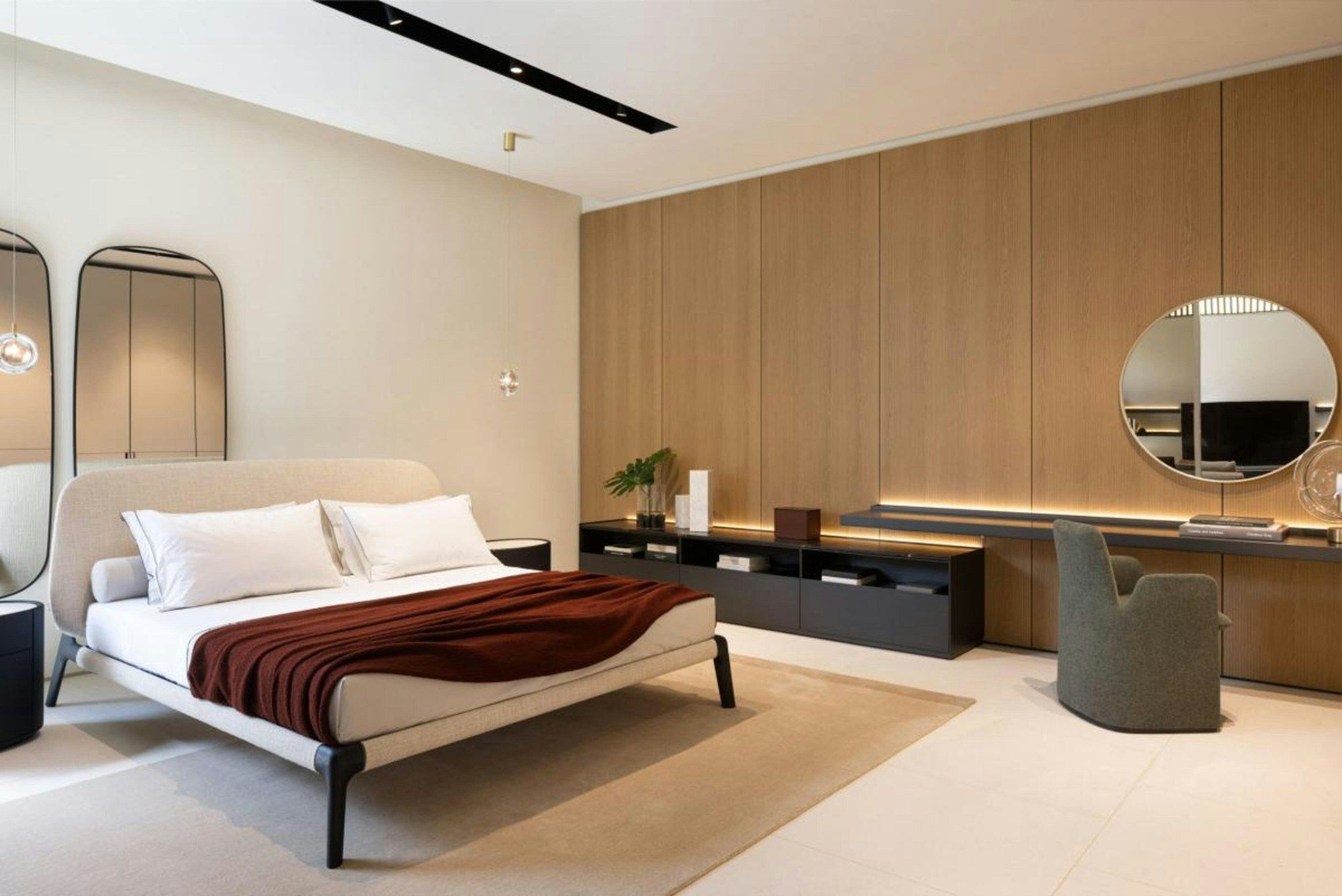 Bedroom with timber panelling and a round mirror