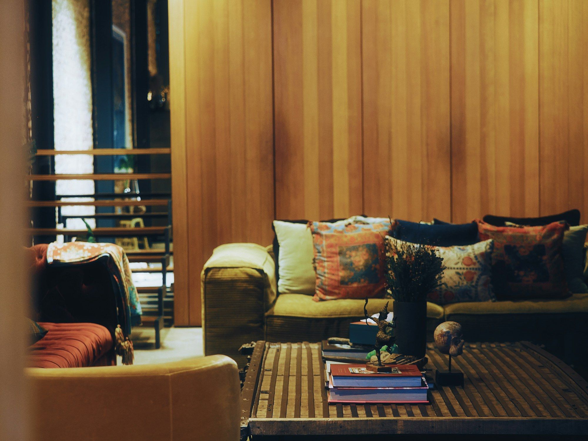 Living room with warm wood walls and patterned cushions