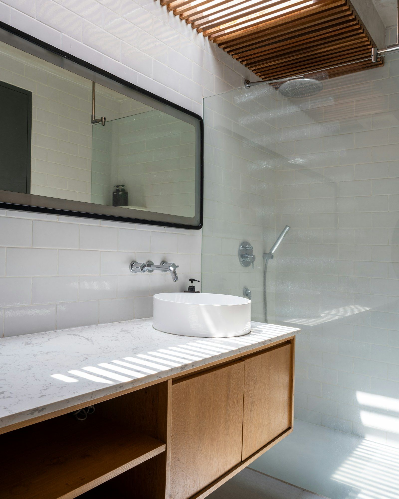 Bathroom with a stone basin and a walk-in shower