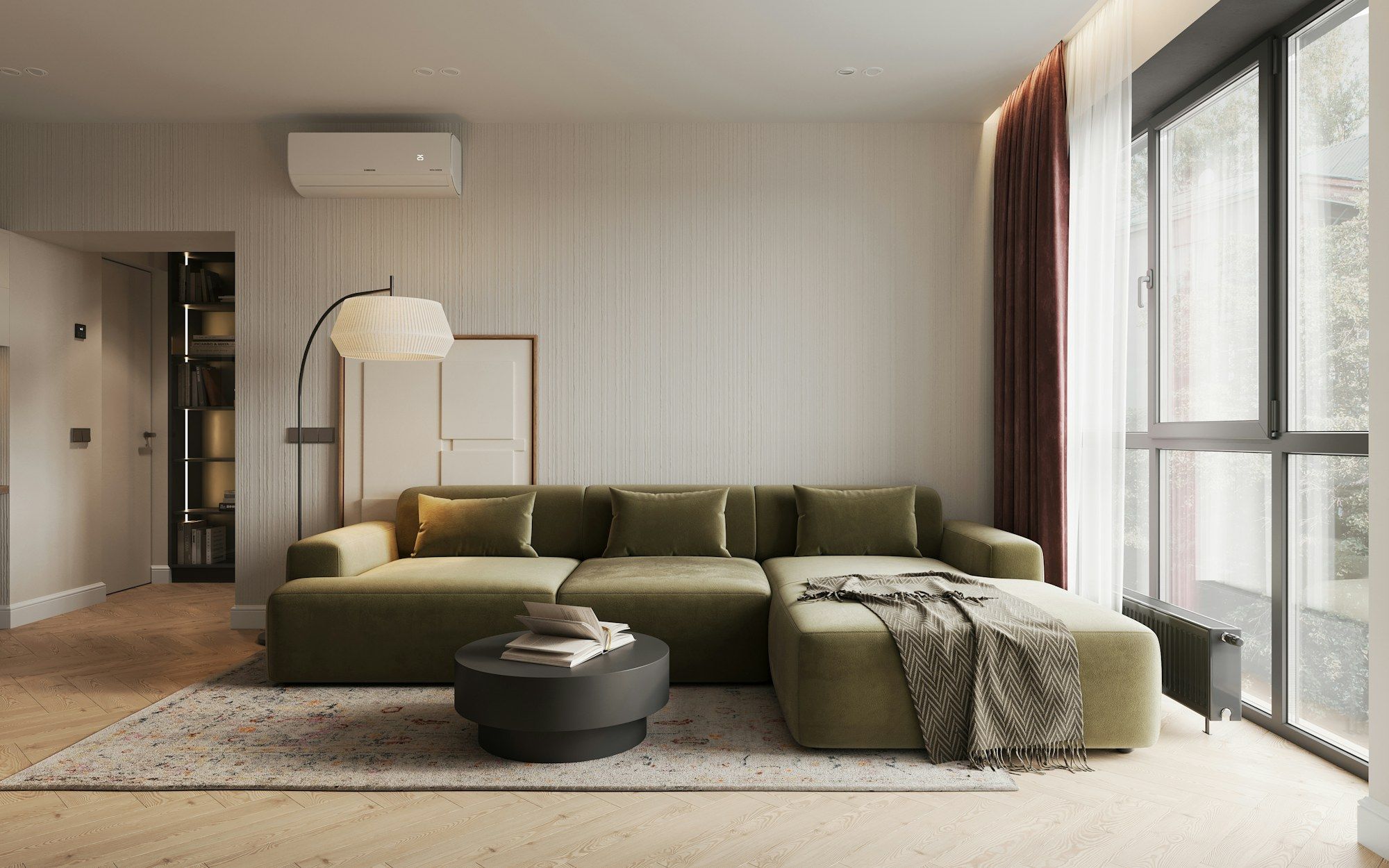 Living room with a deep green sofa and floor-to-ceiling windows