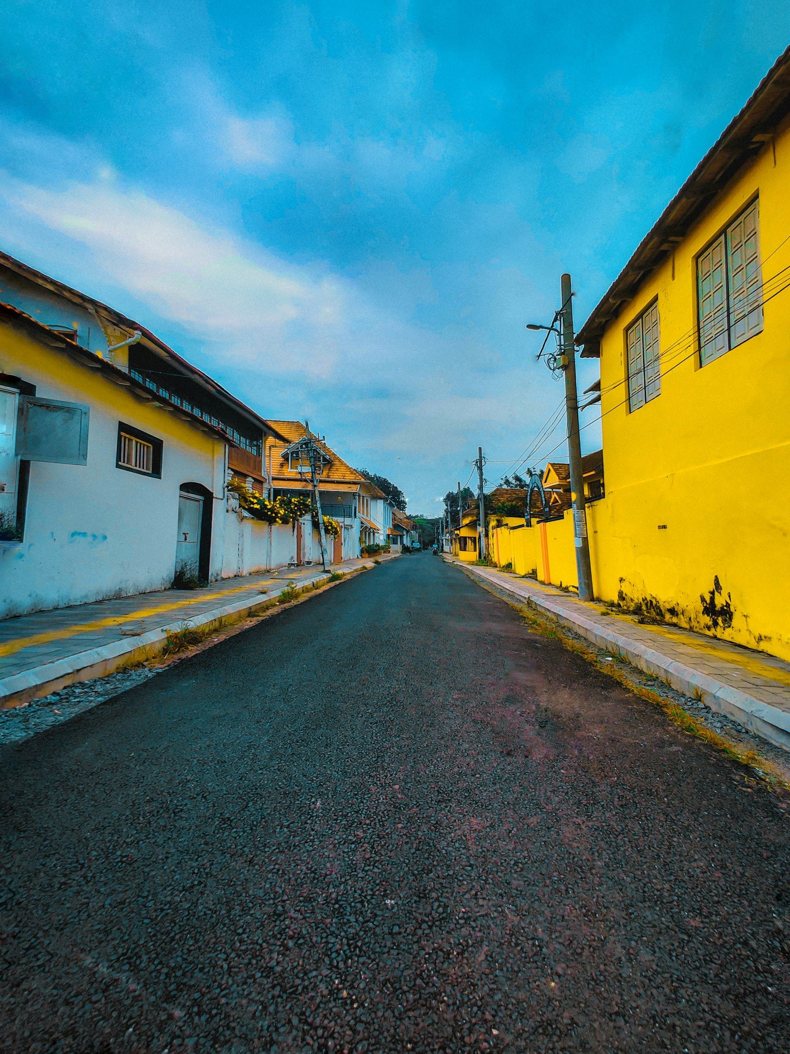 A quiet street lined with yellow heritage buildings